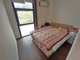 2 yatak odalı bahçeli daire + full eşyalı + depo odası + 3 ortak yüzme havuzu + amfitiyatro + okullara ve Girne şehir merkezine yakınlık