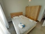1 yatak odalı yeniden satılık tatil dairem + tamamen mobilyalı + ortak yüzme havuzları + çatı katı havuzu + spor salonu + kumsal + Pre 74 Türk tapu senedi