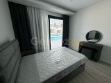 Long Beach, Elysium'da kiralık 2+1 yeni daire. Terastan havuz çıkışlı. Aidat dahil 750 GBP